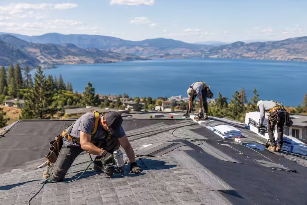 Blue Jay Roofing crew installing architectural shingles on an Okanagan home overlooking the lake and mountains