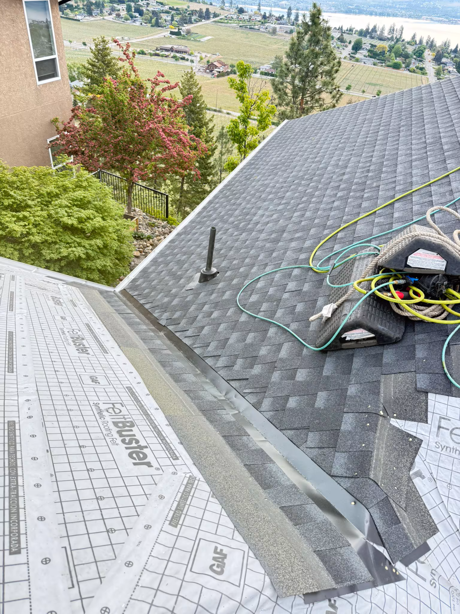 New roof installation with chimney flashing detail on residential property — West Kelowna