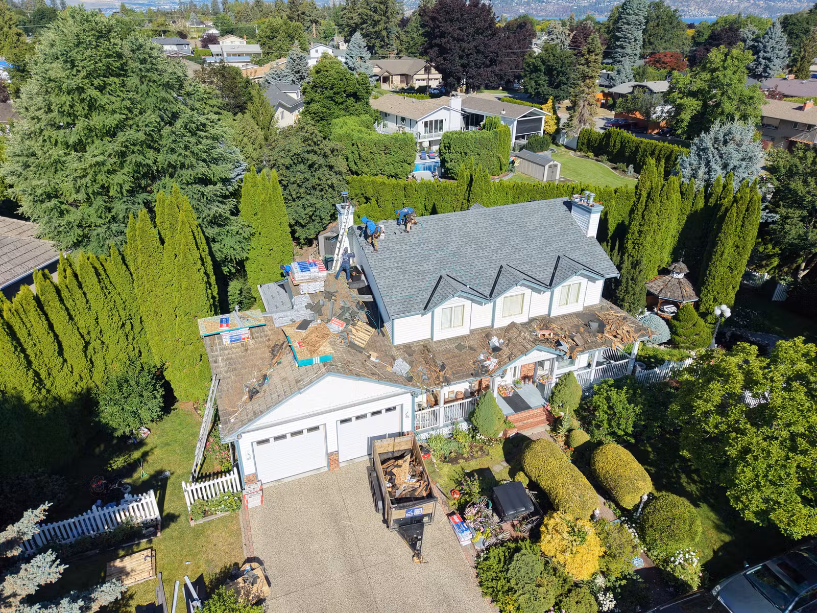 Wide aerial view of a completed multi-plane roof replacement in Kelowna