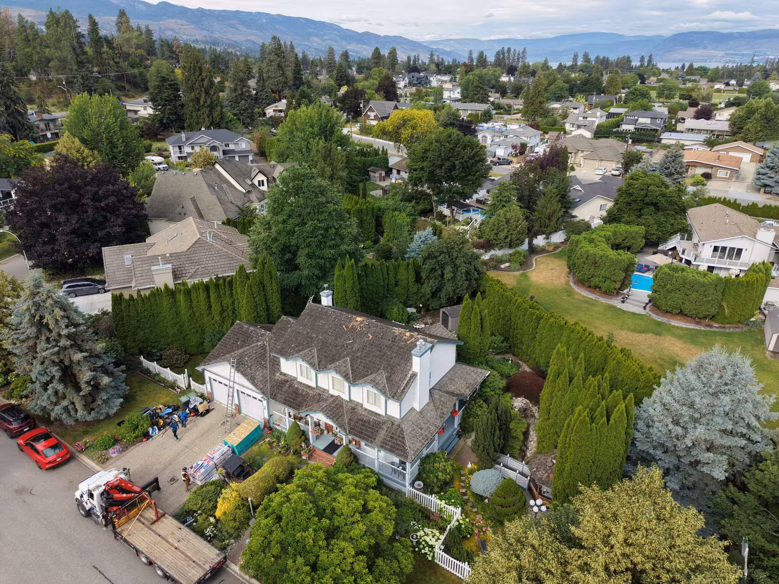 Completed Kelowna roof replacement shown from above in its neighbourhood