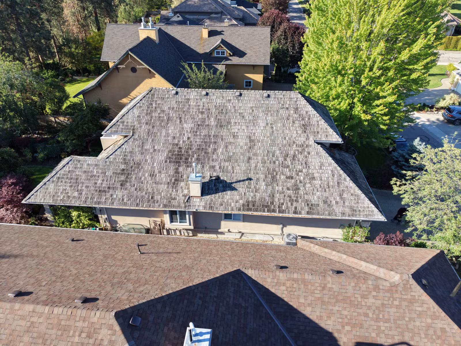Weathered asphalt shingles before replacement on a Gallagher's Canyon roof in East Kelowna
