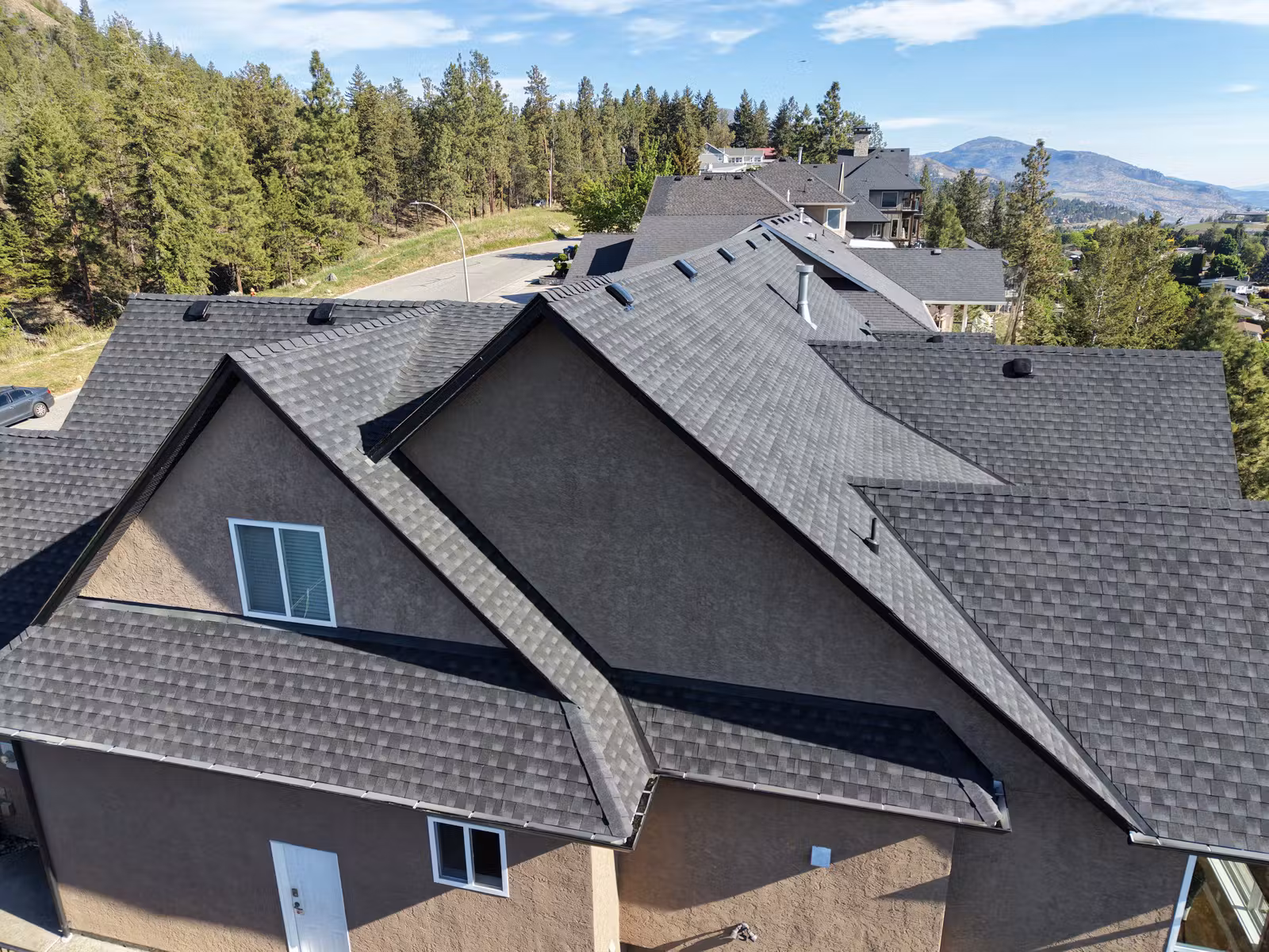 Close aerial view of dark shingles and roof valleys in Lakeview Heights